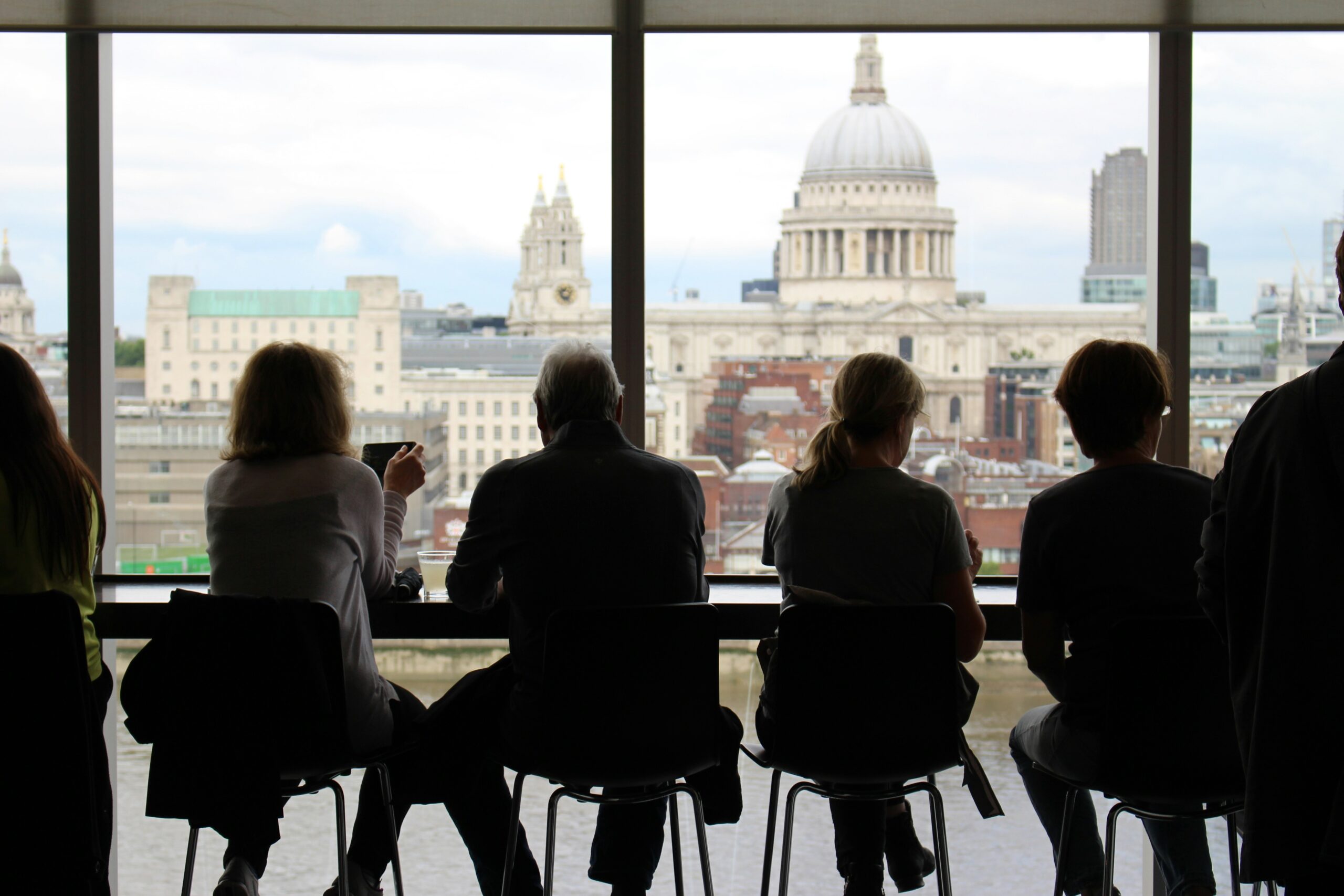 Specialist Recruitment Agency UK - Group of professionals in an office looking onto a view of St. Paul's Cathedral and The city of London